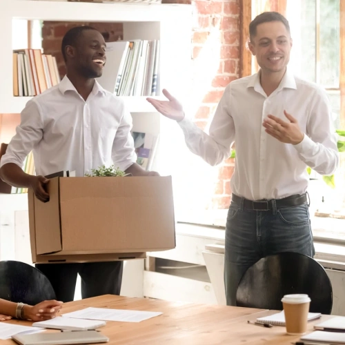 Office workers packing box