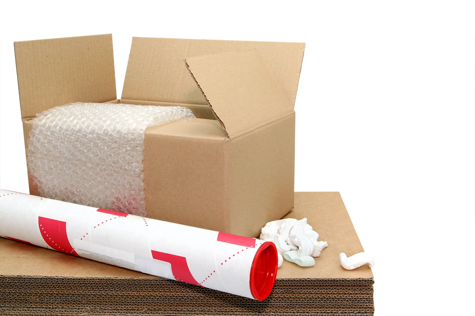 Stack of cardboard boxes, bubble wrap, packing peanuts, and other protective shipping supplies